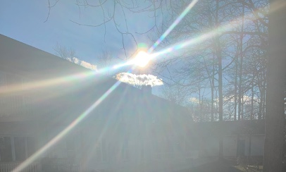 Dazzling sun rays over residential roof